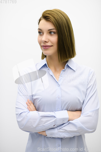 Image of Portrati shot of beautiful blond businesswoman standing with arms crossed at isolated white background.