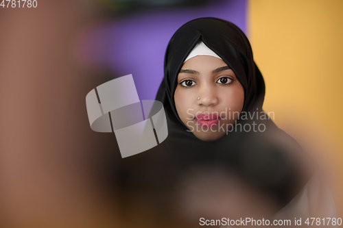 Image of muslim woman with a beautiful smile wearing a hijab poses in the studio