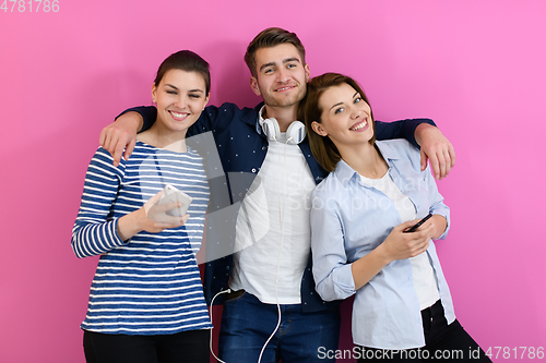 Image of group of friends have fun and dance while using a cell phone and headphones