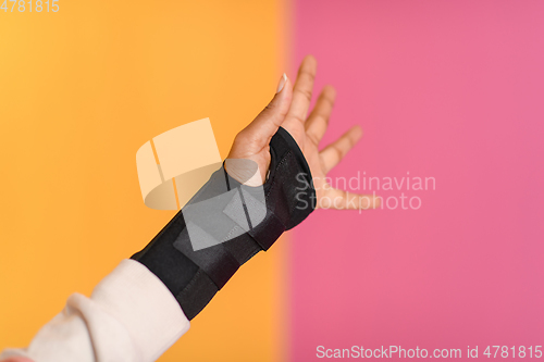 Image of hand injury. a female injured hand on a yellow background