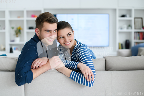 Image of a young married couple enjoys sitting in the large living room