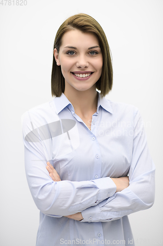 Image of Portrati shot of beautiful blond businesswoman standing with arms crossed at isolated white background.