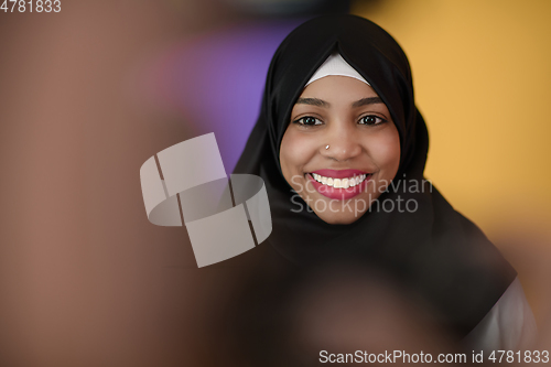 Image of muslim woman with a beautiful smile wearing a hijab poses in the studio