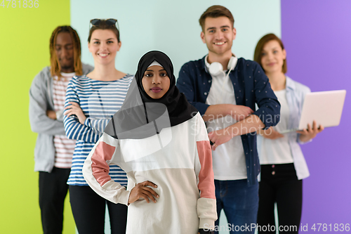 Image of group of diverse teenagers posing in a studio, determined teenagers in diverse clothing.