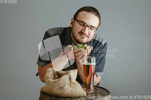 Image of Confident young male brewer with self crafted beer