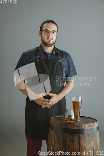 Image of Confident young male brewer with self crafted beer