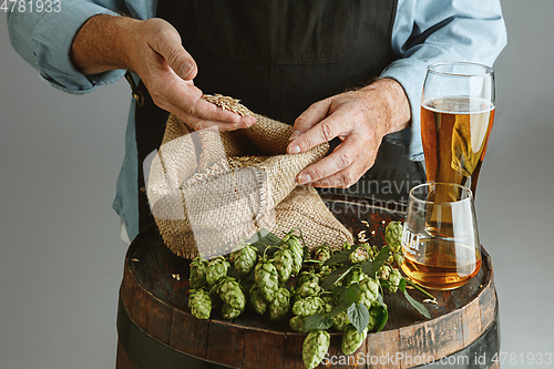 Image of Close up of confident senior man brewer with self crafted beer