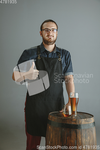 Image of Confident young male brewer with self crafted beer