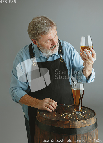 Image of Confident senior man brewer with self crafted beer