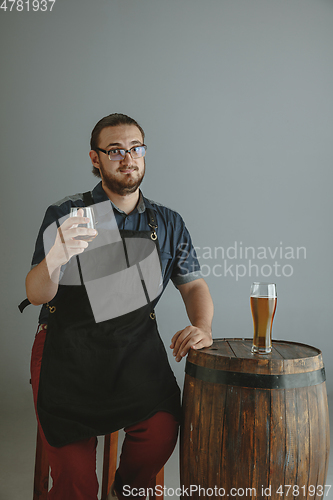 Image of Confident young male brewer with self crafted beer