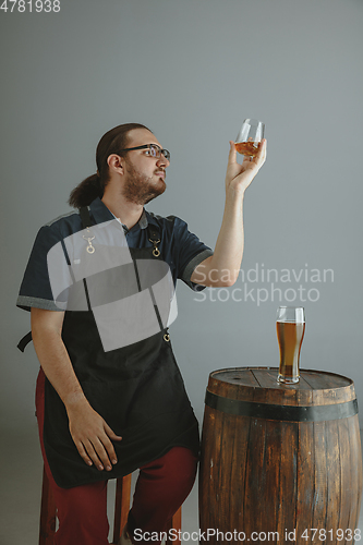 Image of Confident young male brewer with self crafted beer