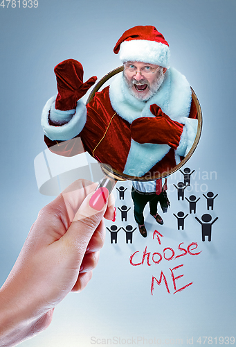 Image of Happy Christmas Santa Claus greeting from the magnifying glass