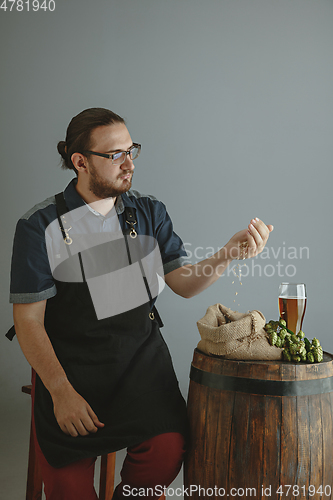 Image of Confident young male brewer with self crafted beer