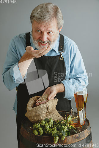 Image of Confident senior man brewer with self crafted beer
