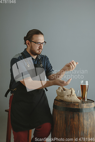 Image of Confident young male brewer with self crafted beer