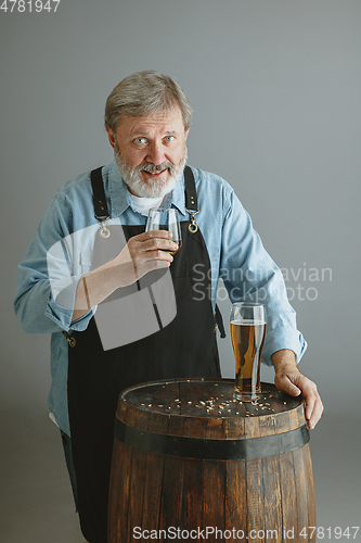 Image of Confident senior man brewer with self crafted beer