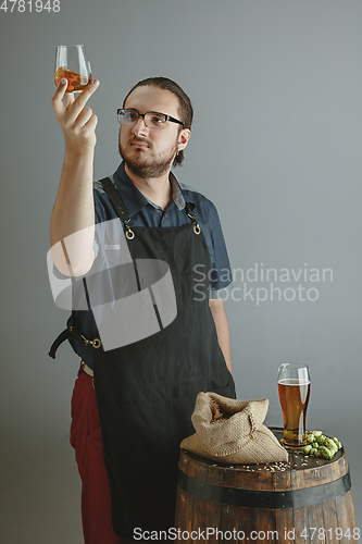 Image of Confident young male brewer with self crafted beer