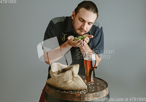 Image of Confident young male brewer with self crafted beer