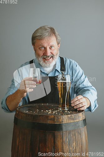 Image of Confident senior man brewer with self crafted beer