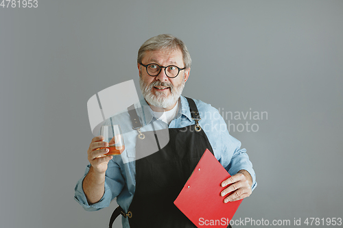 Image of Confident senior man brewer with self crafted beer