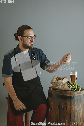 Image of Confident young male brewer with self crafted beer