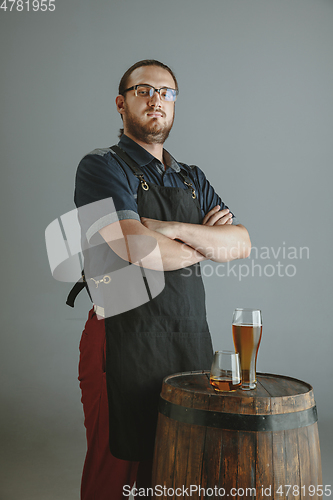 Image of Confident young male brewer with self crafted beer