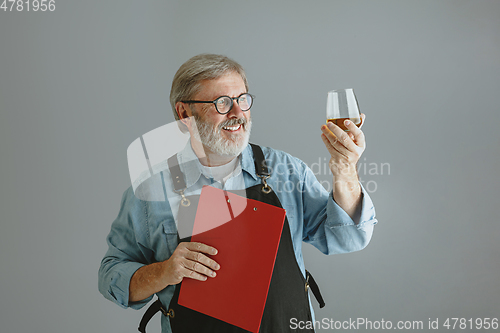 Image of Confident senior man brewer with self crafted beer