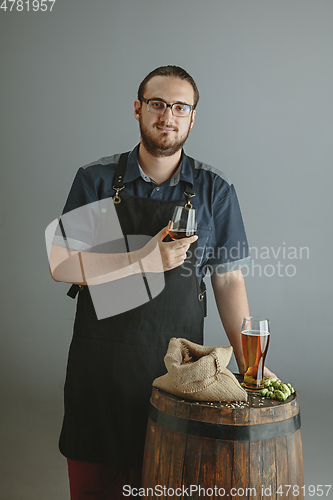 Image of Confident young male brewer with self crafted beer