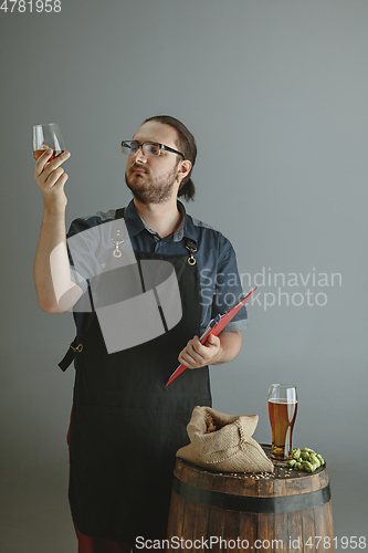 Image of Confident young male brewer with self crafted beer