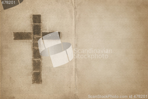 Image of christian cross on old book