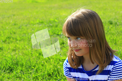 Image of portrait of girl on the green grass background