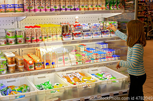 Image of girl in shop of dairy products