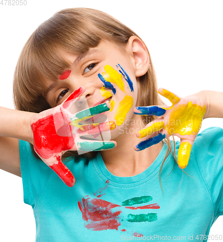 Image of Portrait of a cute girl playing with paints