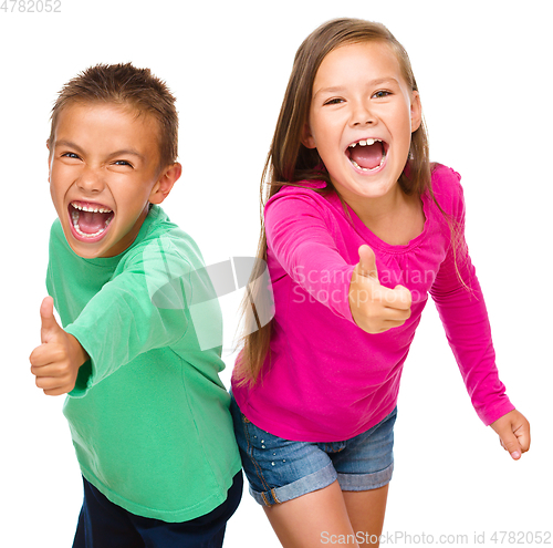 Image of Little boy and girl are showing thumb up sign