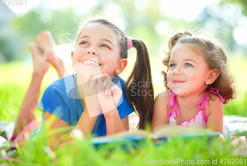 Image of Two little girls are reading book