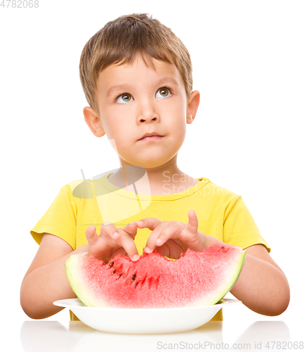 Image of Little boy is eating watermelon