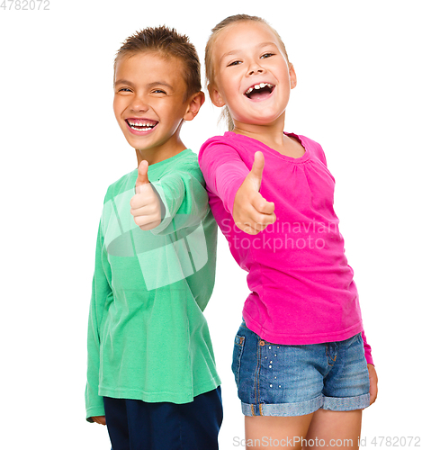 Image of Little boy and girl are showing thumb up sign