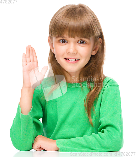 Image of Little girl is rising his hand up