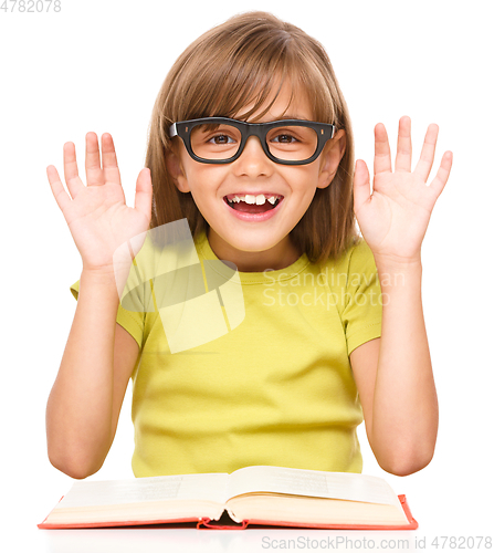Image of Little girl is reading a book