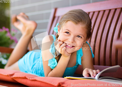 Image of Little girl is reading a book