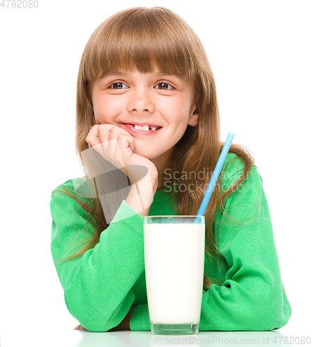 Image of Cute little girl with a glass of milk