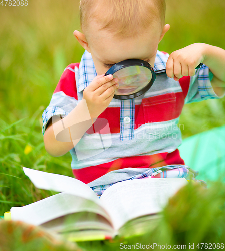 Image of Little boy is reading book