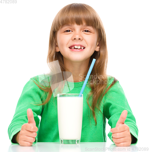 Image of Cute little girl with a glass of milk