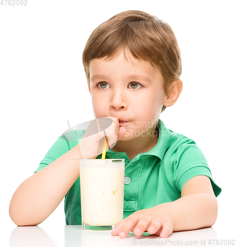 Image of Cute little boy with a glass of milk