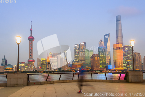 Image of Jogging man, illuminated Shanghai cityscape