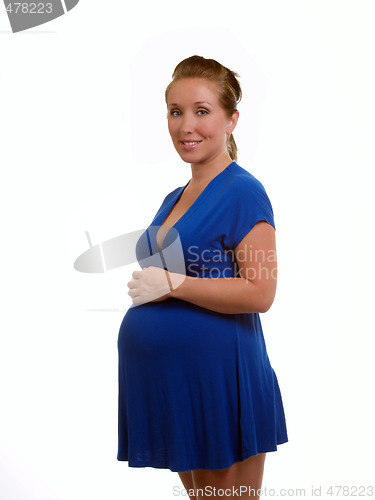 Image of Young pregnant woman in solid blue dress
