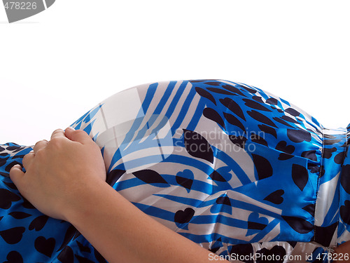 Image of Pregnant womans belly in blue and white dress