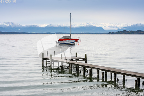 Image of Starnberg lake jetty and boats Alps in winter season