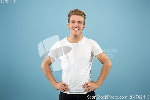 Image of Caucasian young man\'s half-length portrait on blue background