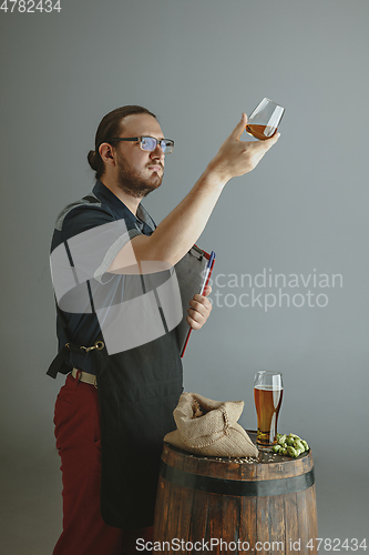 Image of Confident young male brewer with self crafted beer